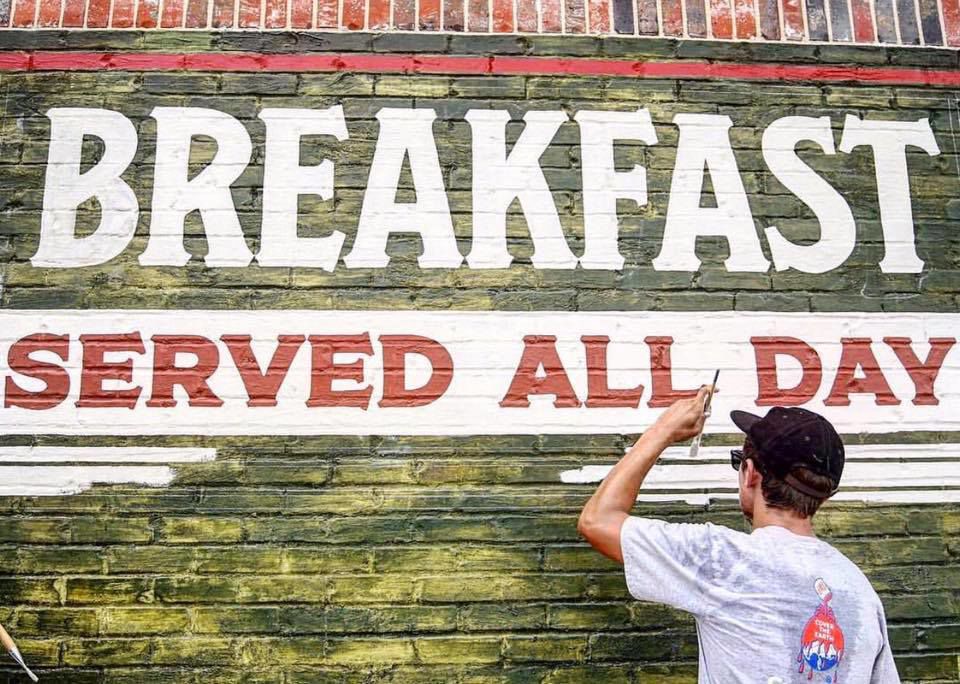 Prince puts the finishing touches on one of his signs at The Midtowner in Hattiesburg. (Facebook).jpg